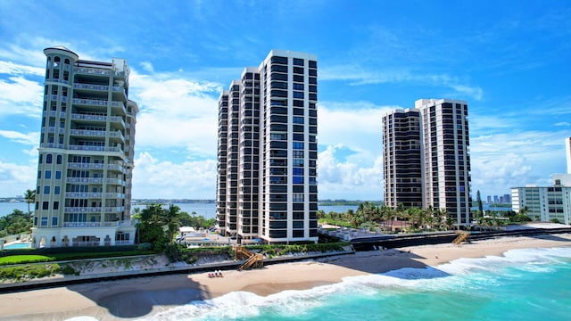 view of property with a beach view and a water view