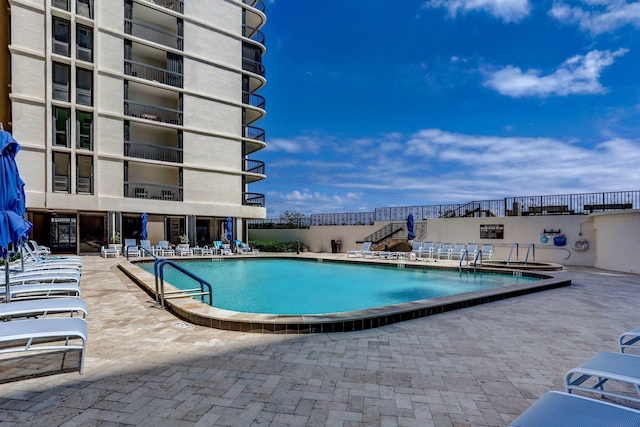 view of swimming pool featuring a patio area