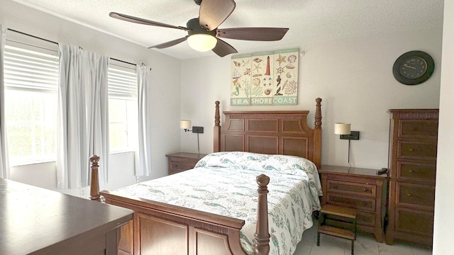 bedroom with ceiling fan and a textured ceiling