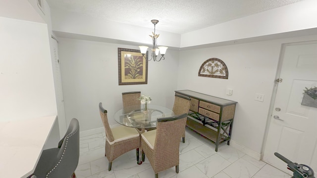 dining area featuring an inviting chandelier and a textured ceiling