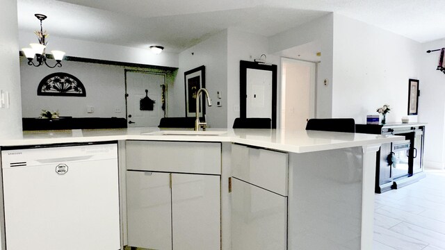 kitchen with an inviting chandelier, dishwasher, kitchen peninsula, sink, and white cabinetry