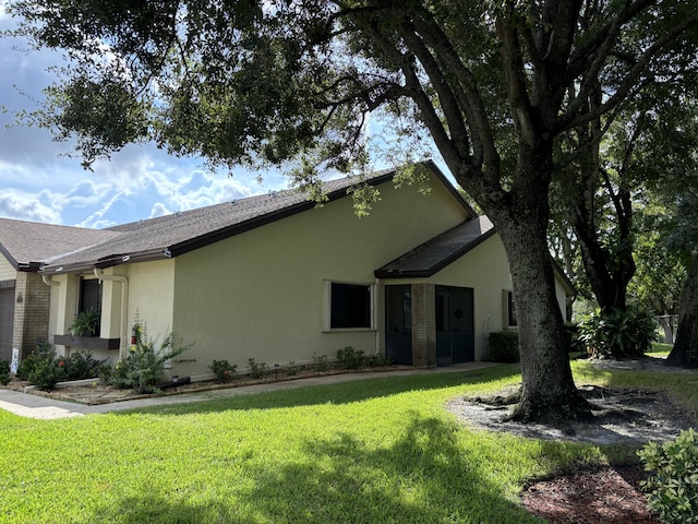 view of side of home featuring a yard