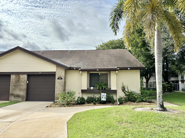 single story home featuring a garage and a front lawn