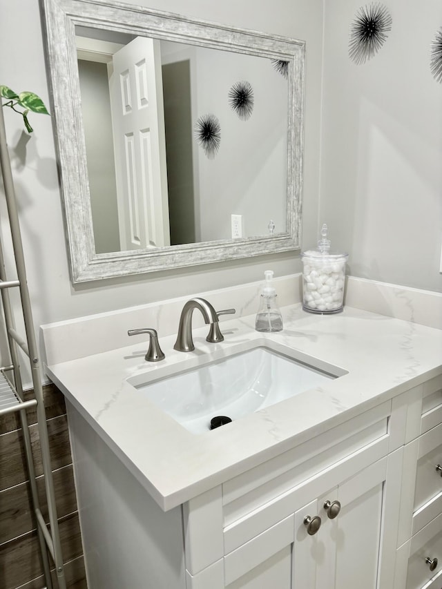 bathroom with vanity and hardwood / wood-style flooring