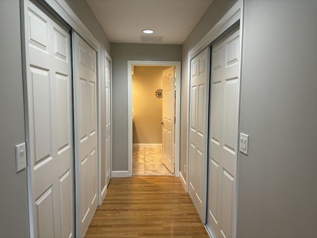 corridor with light hardwood / wood-style flooring