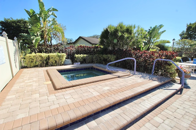 view of swimming pool with a patio area and an in ground hot tub