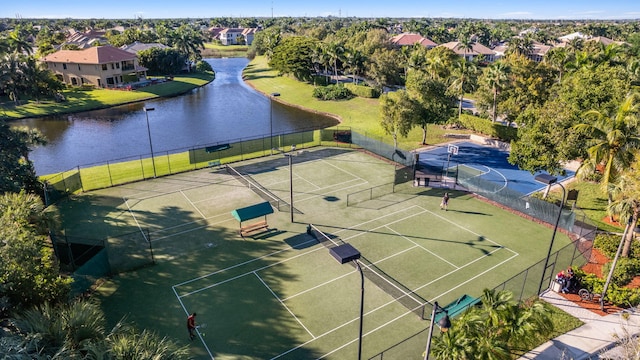 view of sport court featuring a water view