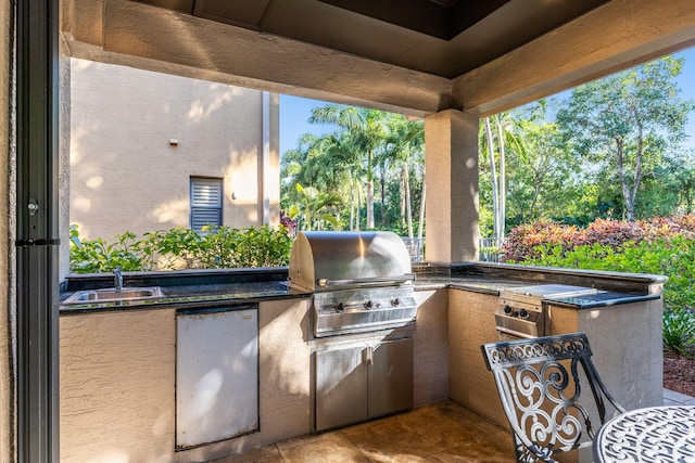 view of patio with exterior kitchen, sink, and grilling area