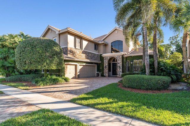 view of front of home featuring a front yard and a garage