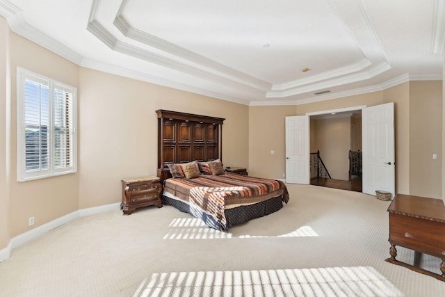 bedroom with crown molding, carpet floors, and a tray ceiling