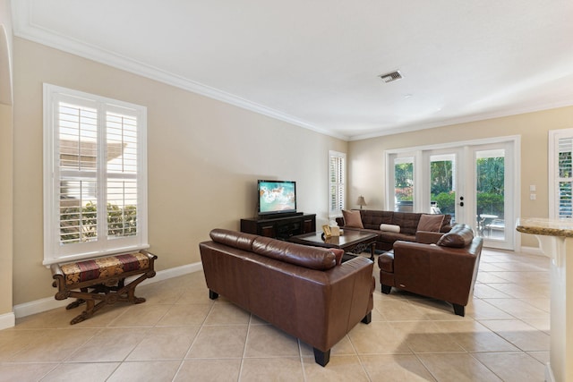 living room featuring crown molding, plenty of natural light, and light tile patterned flooring