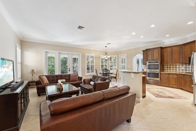 living room featuring a wealth of natural light, light tile patterned floors, and a chandelier