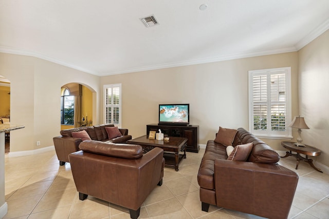 tiled living room featuring crown molding and a healthy amount of sunlight