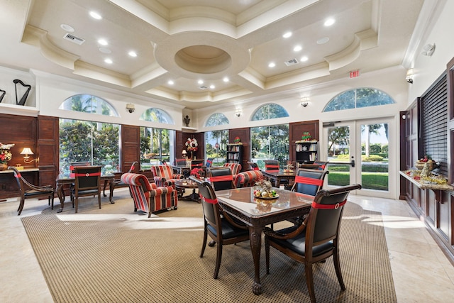 dining room with a high ceiling, coffered ceiling, plenty of natural light, and ornamental molding