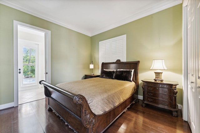 bedroom with crown molding and dark hardwood / wood-style flooring