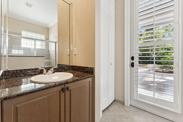 bathroom featuring crown molding, a shower with shower door, vanity, and tile patterned flooring