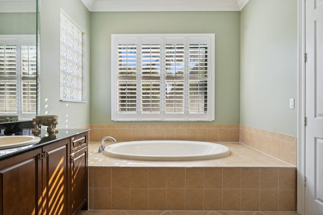 bathroom with vanity, tiled tub, and ornamental molding