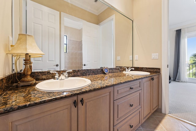 bathroom featuring tile patterned flooring, ornamental molding, and vanity