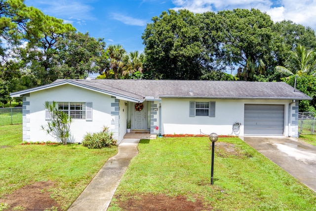 ranch-style house with a garage and a front lawn