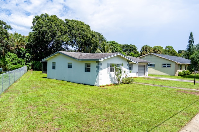 single story home with a garage and a front yard