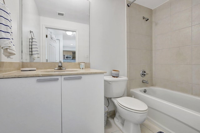 full bathroom with tiled shower / bath, vanity, toilet, and tile patterned flooring