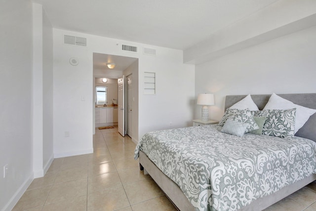 tiled bedroom featuring ensuite bathroom