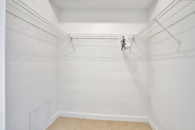 walk in closet featuring tile patterned flooring