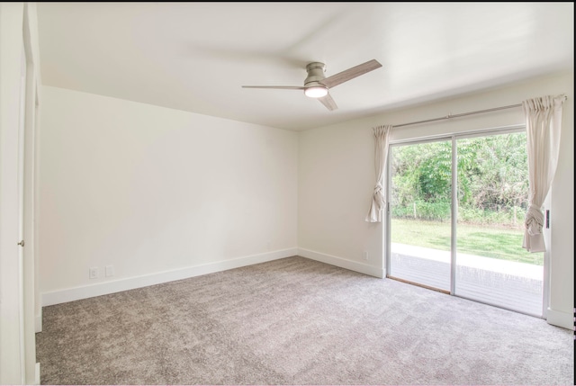 carpeted spare room featuring ceiling fan