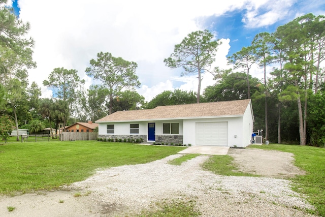 ranch-style house featuring central AC, a front lawn, and a garage