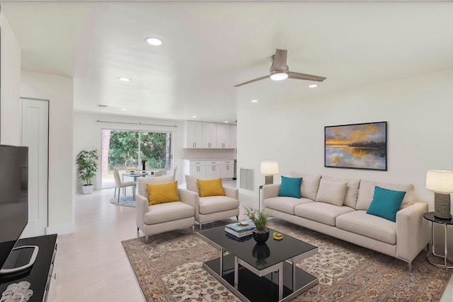 living room featuring ceiling fan and light hardwood / wood-style flooring