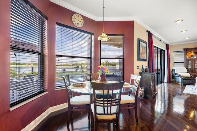 dining room with ornamental molding and hardwood / wood-style floors