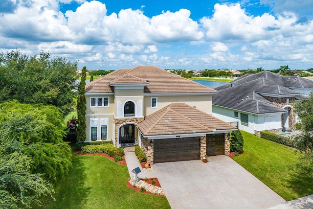 view of front of property with a garage and a front lawn