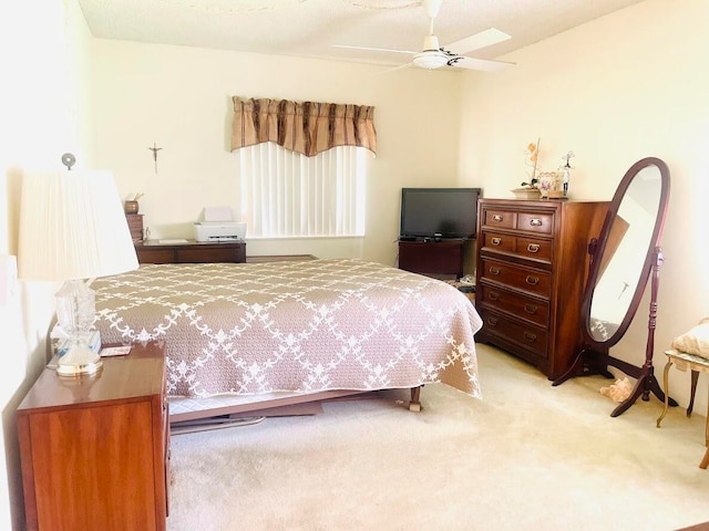 bedroom featuring ceiling fan and light carpet