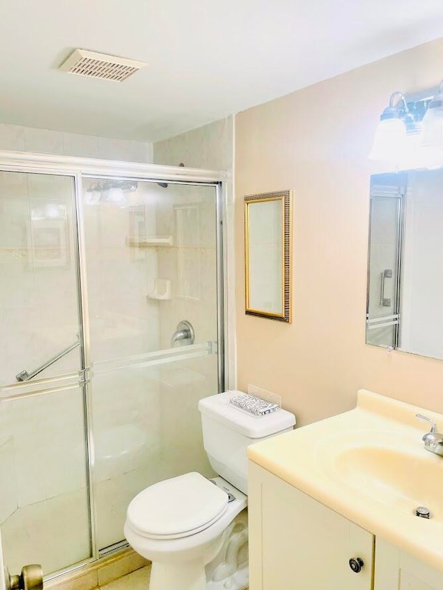 bathroom with an enclosed shower, toilet, and vanity