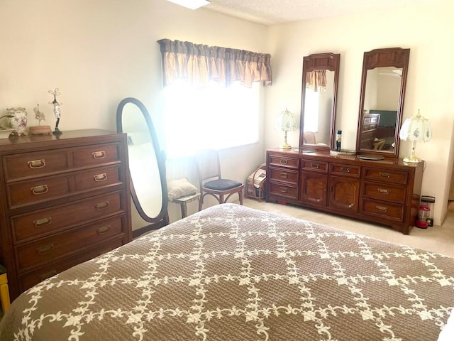 bedroom with a textured ceiling and light carpet