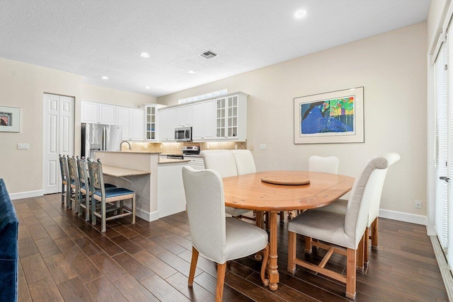 dining room featuring a textured ceiling and sink