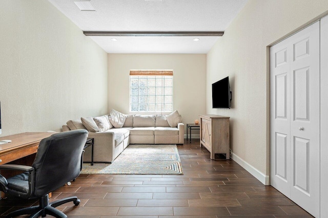 living room with beamed ceiling and a textured ceiling