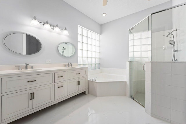 bathroom featuring vanity, tile patterned flooring, and plus walk in shower