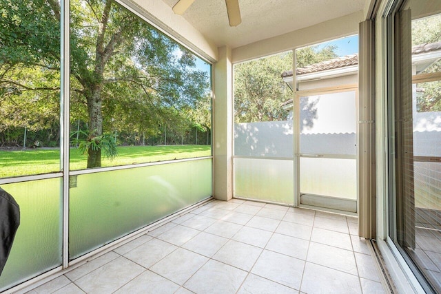 unfurnished sunroom featuring ceiling fan