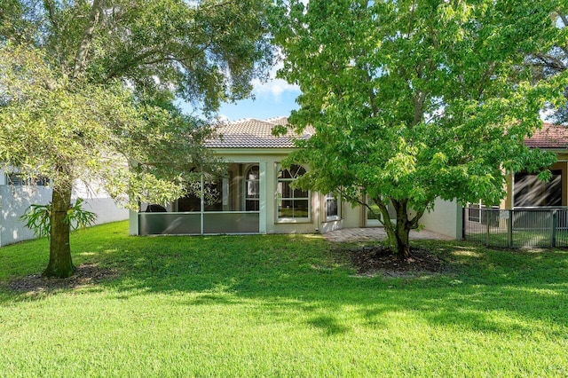 rear view of house with a yard