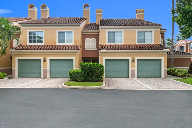 mediterranean / spanish-style home with a garage