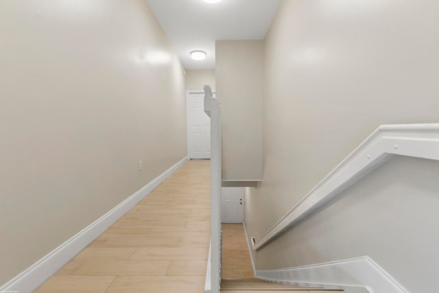 stairs featuring hardwood / wood-style flooring