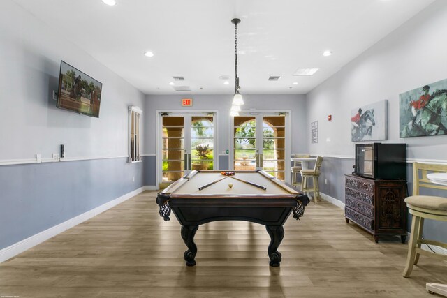 recreation room featuring pool table, light hardwood / wood-style floors, and french doors