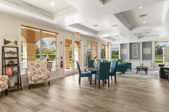 dining room with light wood-type flooring, ornamental molding, coffered ceiling, and beam ceiling