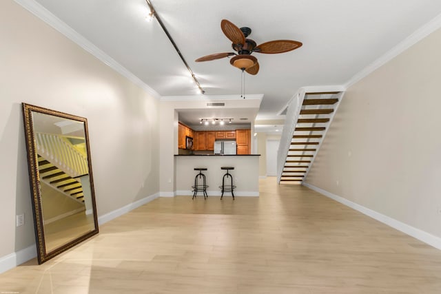 unfurnished living room featuring ceiling fan, light hardwood / wood-style flooring, crown molding, and rail lighting