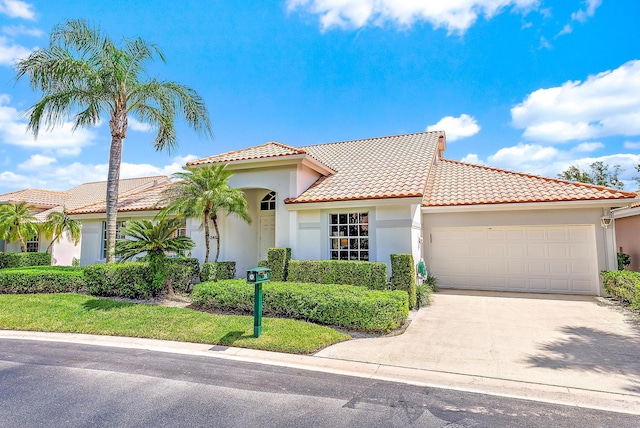 mediterranean / spanish-style home featuring a garage and a front lawn