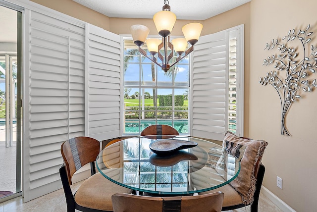 dining space with a textured ceiling and an inviting chandelier