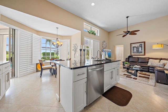 kitchen with ceiling fan with notable chandelier, decorative light fixtures, stainless steel dishwasher, sink, and white cabinetry