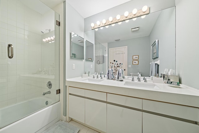 bathroom with shower / bath combination with glass door, vanity, and tile patterned flooring