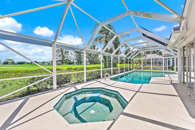 view of swimming pool featuring glass enclosure, a patio area, and an in ground hot tub